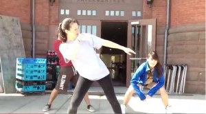 Kelsey Siegel '13 (center) teaches her flash mob dance to Wesleyan University students outside of Fayerweather Beckham Hall. 